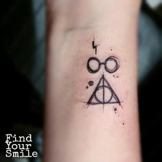 a harry potter symbol tattoo on the wrist