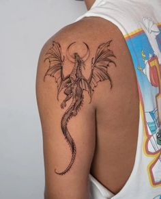 a man with a dragon tattoo on his arm