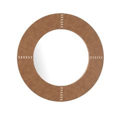 a circular mirror with white stitching around it