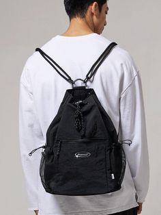 This is a casual and unique bag by BSMT that is made out of high quality and sturdy material. With distinctive mood of the design and comfortable wear, you can style it for your casual daily outfit.- Adjustable string and stopper on side and top- Miimal logo print detail- Casual and trendy mood Black Chest Bag With Zipper Pocket For Streetwear, Large Capacity Nylon Sling Bag, Large Capacity Nylon Chest Backpack, Nylon Backpack Shoulder Bag For Streetwear, Modern Nylon Chest Bag For Outdoor Activities, Sporty Black Chest Bag For Daily Use, Practical Nylon Gym Bag Backpack, Multifunctional Backpack For Streetwear, Sporty Black Chest Bag