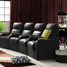 a living room filled with black leather chairs