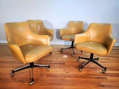 two yellow office chairs sitting on top of a hard wood floor next to each other