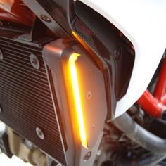 the front light of a motorcycle is glowing yellow