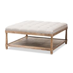 a wooden coffee table with a white cushion on top and measurements for the bottom shelf