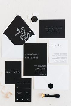 an assortment of black and white wedding stationery with calligraphy on the envelopes