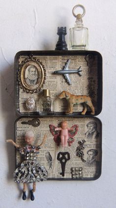 two suitcases with magnets on them are decorated with miniature figurines and other items