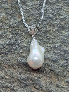 Stunning large white baroque pearl silver measures approximately 25 mm long by 15 mm wide.  Pearl is set on gorgeous oversized silver filigree bail. Pendant only available or purchase with high quality 20 inch nickel-free Italian stainless chain. Amazing luster with hints of gold, pink and blue depending on the light.  Photos are not filtered adding only some adjustment for brightness. I do my very best to depict all my pearls as accurately as possible. Please keep in mind, due to the unique bea Elegant Teardrop Large Pendant Jewelry, Classic Silver Teardrop Pearl Necklace, Classic Silver Pearl Drop Necklace, Drop Baroque Pearl Wedding Jewelry, Silver Teardrop Pendant Pearl Necklace For Formal Occasions, White Pearl Pendant Jewelry, Elegant Silver Drop Pearl Necklace, Classic White Pendant Pearl Necklace, Sterling Silver Pearl Drop Necklace Pear Shape