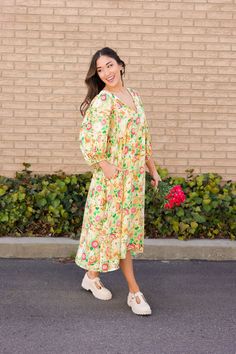 Add a pop of color to your wardrobe with our Aliyah Tie Front Puff Sleeve Midi Dress in Yellow. This beautiful dress features a playful tie detail, short sleeves, and a charming floral print. Perfect for a sunny summer day! Paired with THE GRETA PLATFORM LOAFERS IN BONE V-neck with tie string Midi length Puff sleeves Pockets Clean hem Lined Self: 100% Rayon, Lining: 100% Polyester Model is 5'5" wearing a small. Length (shoulder to hem): Small: 48”, Medium: 48.5”, Large: 49” To view our return po Playful Short Sleeve Dresses For Brunch, Yellow Cotton Puff Sleeve Dress, Yellow Puff Sleeve Cotton Dress, Playful Puff Sleeve Summer Dress, Casual Yellow Puff Sleeve Midi Dress, Yellow Cotton Midi Dress For Garden Party, Yellow Cotton Midi Dress With Short Sleeves, Casual Yellow Puff Sleeve Dress, Spring Yellow Midi Dress With Lemon Print