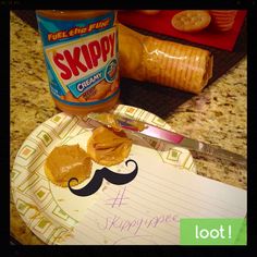 a paper plate topped with peanut butter next to a jar of jelly and a knife