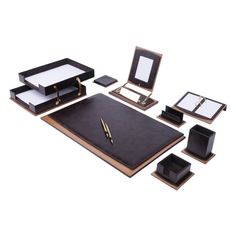 an assortment of black and gold desk accessories