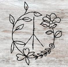 a peace sign with flowers and leaves drawn on the side of an unfinished piece of wood