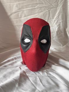 a deadpool mask is shown on a white sheet