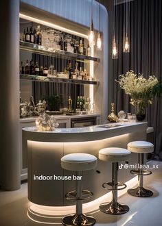 an indoor bar with stools in front of it