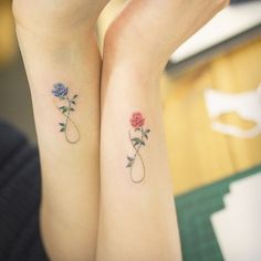 two matching tattoos with roses on their arms