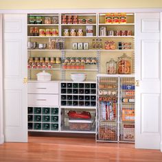 an organized pantry with lots of food and containers on the shelves in front of it