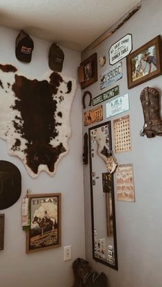 the wall is covered with various pictures and signs, including a cowhide rug on the wall