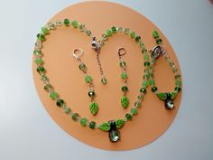 This set has different types of green, and really looks really pretty, 3 pieces, one necklace, one bracelet and one pair of earrings, if you want other size please contact me, Normal response time is between 12-24 hours, The  clasp on the necklace and bracelet are stainless steel including the chain on the necklace, the rest of the  metal is silver plated, free nickel, {durable material] the size of the beads are 6mm and the little clear beads 4mm,  the leaves are around 6x10mm Length of the necklace is 18 inches and 2 extra  inches with the stainless steel chain,   The bracelet is 7 inches,  long and the earrings  are around 3 inches with the ear wire, Usually you receive the order between 5-7 business day thought USPS first class. Green Adjustable Jewelry With Matching Earrings, Handmade Green Jewelry With Czech Glass, Handmade Green Czech Glass Jewelry, Green Jewelry Sets With Matching Earrings For Gifts, Green Czech Glass Jewelry Gift, Green Handmade Costume Jewelry, Green Bracelet With Lobster Clasp, Handmade Green Jewelry Sets With Round Beads, Green Nickel-free Costume Jewelry