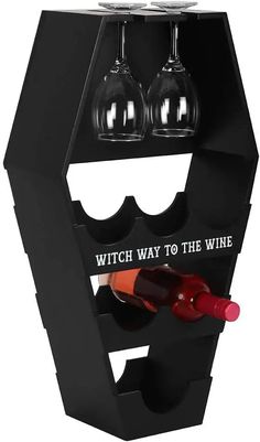 a wine bottle holder with two glasses in it and the words witch way to the wine