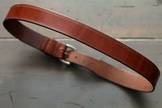 "These every day leather belts are made using thick, durable, full-grain harness leather from the Wickett & Craig tannery. Designed to be at your service for many years, they will take on a wonderful rich character with age. They're 1.5\" in width, with a tapered, low profile tail-end. Its hand-stitched construction is fitted with a solid brass buckle with a muted, satin-steel finish. For added comfort and durability, all edges are rounded and burnished smooth with a soft wax finish. Handcra Everyday Bridle Leather Belts And Suspenders With Removable Belt, Bridle Leather Belts And Suspenders For Everyday Use, Leather Belt Buckles With Removable Belt For Everyday Use, Leather Belt Buckle With Removable Belt For Everyday Use, Brown Bridle Leather Belts And Suspenders For Everyday, Brown Leather Strap Belt Buckle For Everyday Use, Masculine Brown Belt For Everyday Use, Brown Belt For Everyday Use, Rich Character