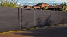 a black fence in front of some houses