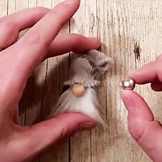 a person holding a tiny bird in their hands