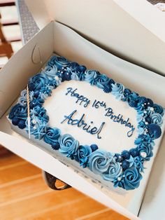 a birthday cake with blue frosting in a box