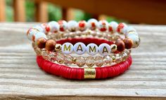 This stack is beautiful! I love the old fashion floral beads, and the red Heishi bracelet!  ♥️This stack consists of three bracelets.  * A floral porcelain and wood bead bracelet. I can add any name or word.  * A red Heishi bracelet with a gold spacer bead.  * A light brown glass bead bracelet with tiny gold spacer discs.  ♥️All gold beads are 14k non-tarnish beads. ♥️{Sizing}  The average size is 7. I can make these in any size! Please see the measurement directions in the item images to get your perfect fit!  ♥️{Personalization}  I can change the wording to any name or word. Please let me know what you want on your bracelet!  Thank you! Red Beaded Bracelets For Mother's Day, Adjustable Red Stackable Beaded Bracelets, Adjustable Stackable Red Beaded Bracelets, Everyday Red Stretch Bracelet With Round Beads, Red Adjustable Stackable Beaded Bracelets, Red Beaded Bracelets For Everyday Wear, Red Round Beads Bracelet For Everyday, Red Stackable Bracelets With Round Beads, Adjustable Red Stackable Stretch Bracelet