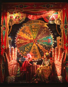 an elaborate display with hands and lights in the shape of a wheel of fortune on display