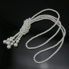 A unique take on classic Ivory pearls. Two long strings of pearl beads are knotted at the center and feature sparkling crystal dividers at the tassels. The necklace is completely convertible, wear it as shown, separate the strands or wear it as a scarf. The perfect accessory for any formal occasion or for a glamorous costume! Pair it with our matching Ivory Pearl Bead & Crystal Earrings Material: Simulated Pearls Length: 16 inches Comes in a gift box for easy gift giving. (Reg $49.00) Cheap Pearl Chain Long Necklace, Luxury Single Strand Beaded Necklaces As Gift, Luxury Single Strand Long Beaded Necklace, Elegant Luxury Single Strand Beaded Necklace, Luxury Long White Beaded Necklaces, Elegant Pearl Beaded Lariat Necklace, Elegant Beaded Pearl Lariat Necklace, Elegant Party Necklace With 108 Beads, Elegant Necklace With 108 Beads For Party