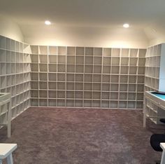 an empty room with shelves and desks in it