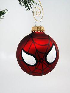 a spiderman ornament hanging from a christmas tree