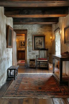 a room with a rug, chair and pictures on the wall next to an entry way