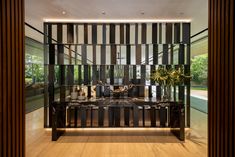 a living room filled with furniture next to a wooden floor covered in black and white striped walls