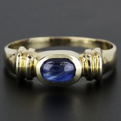 Vintage 14k Yellow Gold Cabochon Sapphire Anniversary / Cocktail Band Ring This Beautiful Ring Is Made Of 14 Karat Yellow Gold Featuring A Oval Cabochon Sapphire Placed In-Between A Vintage Setting. This Ring Is A Size 7 Although It Can Be Re-Sized If Needed By Any Qualified Jeweler. Please Keep In Mind That On The Inner Right Corner Of The Ring It Is Stamped With "14k." The Ring Weighs A Total Of 1.52 Dwt Which Converts To 2.36 Grams. This Ring Is Perfect For Sapphire Lovers As Well As Vintage Dcor Lovers! Size: 7 (Re-Sizable) Metal: 14 Karat Yellow Gold Weight: 1.52 Dwt // 2.36 Grams Stone: Oval Cabochon Sapphire 5.5 Mm X 4 Mm I-2358* Z-105 Vintage Setting, Sapphire Anniversary, Beautiful Ring, Oval Cabochon, Womens Jewelry Rings, Band Ring, Blue Gold, Beautiful Rings, Band Rings