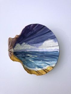 a plate that is sitting on top of a wall next to a white wall with blue and yellow designs