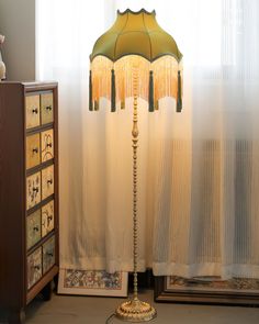 a lamp sitting on top of a table next to a dresser