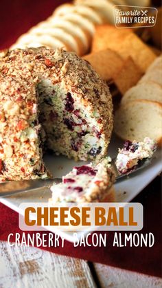 cheese ball cranberry bacon almond bread is cut in half on a white plate