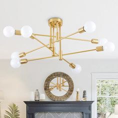 a living room filled with furniture and a fire place under a chandelier above a fireplace