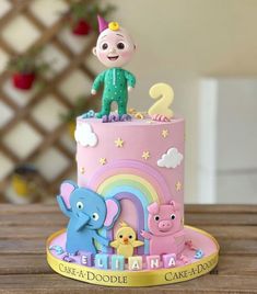 a birthday cake decorated with an elephant and other animals