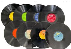 an assortment of old record records are shown in different colors and sizes, including yellow, black, red, green, blue