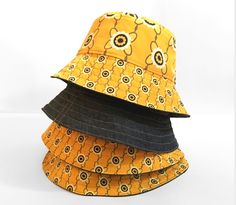 This is the yellow daisy reversible bucket hat giving you two looks in one hat.  Side 1  features a yellow daisy print which has been exclusively designed by myself.  Side 2 is a lightweight mid weight blue denim. It features yellow top stitching and a Stan&Gwyn label on the brim. These hats are very lightweight so easy to pack for holidays or fold up into your pocket at festivals. They also hold their structure due to rows of topstitching on the brim and interfacing.  It's always best if you pr Reversible Yellow Sun Hat For The Beach, Yellow Reversible Sun Hat For Beach, Reversible Yellow Spring Hat, Spring Reversible Yellow Hat, Spring Yellow Reversible Hat, Yellow Reversible Bucket Hat For Beach, Yellow Reversible Adjustable Sun Hat, Yellow Reversible Wide Brim Hat, Yellow Adjustable Reversible Sun Hat