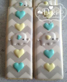 two decorated cookies with elephants and hearts on them