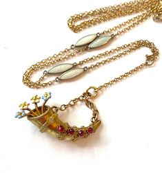 Vintage Victorian Enamel Lariat Necklace Jeweled Cornucopia Fob Gold Filled Watch Chain Horn Charm Enameled Flowers Antique Estate Jewelry Offered here is a beautiful antique Victorian enamel lariat necklace.  It is Gold Filled and features tiny light blue enamel links along with a red jeweled cornucopia horn fob holding enameled flowers.  Unique and stunning pieces.  Easy to remove the cornucopia and hang other jewels - lockets, fobs, charms. Age: circa early 1900s Measurements:  The necklace w Vintage Bridal Necklace, Blue Choker, Gold Lariat Necklace, Victorian Pendants, Edwardian Jewelry, Photo Locket Necklace, Watch Chain, Vintage Victorian, Victorian Jewelry