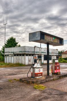 an old gas station with no one at the pump