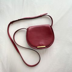 Cuyana Mini Saddle Crossbody Bag - Red Leather - Suede Lining - Adjustable Strap - Minor Scratches On Hardware And Leather From Normal Wear - Most Noticeable Scratch Is On Inside Flap (See Photos) Burgundy Crossbody Shoulder Bag With Gold-tone Hardware, Red Crossbody Flap Bag With Detachable Handle, Red Crossbody Bag With Magnetic Closure, Chic Red Saddle Bag With Adjustable Strap, Chic Red Saddle Bag With Detachable Strap, Chic Red Satchel With Magnetic Closure, Red Saddle Bag With Gold-tone Hardware, Elegant Red Saddle Bag With Gold-tone Hardware, Formal Red Satchel Saddle Bag