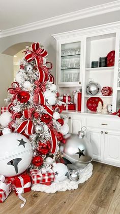 a christmas tree decorated with red, white and silver ornaments