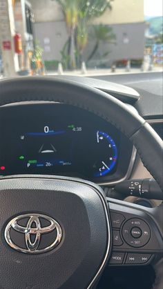 the dashboard of a car with an electronic display on it's dash board and steering wheel