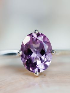 This classic compass style solitaire setting contains a beautiful 2.50ct. natural Rose De France amethyst. This unique setting has prongs in a north, south, east and west configuration. The oval cut stone measures approximately 9x7mm and the band is 2mm wide. The ring is available in sterling silver, and 14k white, yellow, or rose gold. This ring makes a unique promise or engagement ring. Please send me a message if you need a size not listed. * This ring can be customized with any color center Timeless Oval Purple Amethyst Ring, Timeless Purple Oval Amethyst Ring, Timeless Round Amethyst Ring, Classic Oval Lavender Jewelry, Classic Lavender Oval Jewelry, Classic Amethyst Solitaire Ring, Classic Oval Amethyst Ring, Timeless Oval Amethyst Ring For Anniversary, Classic Lavender Amethyst Ring With Prong Setting