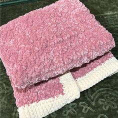 two pink and white towels folded on top of each other