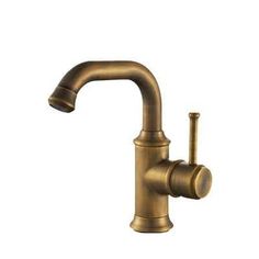 an antique brass faucet on a white background